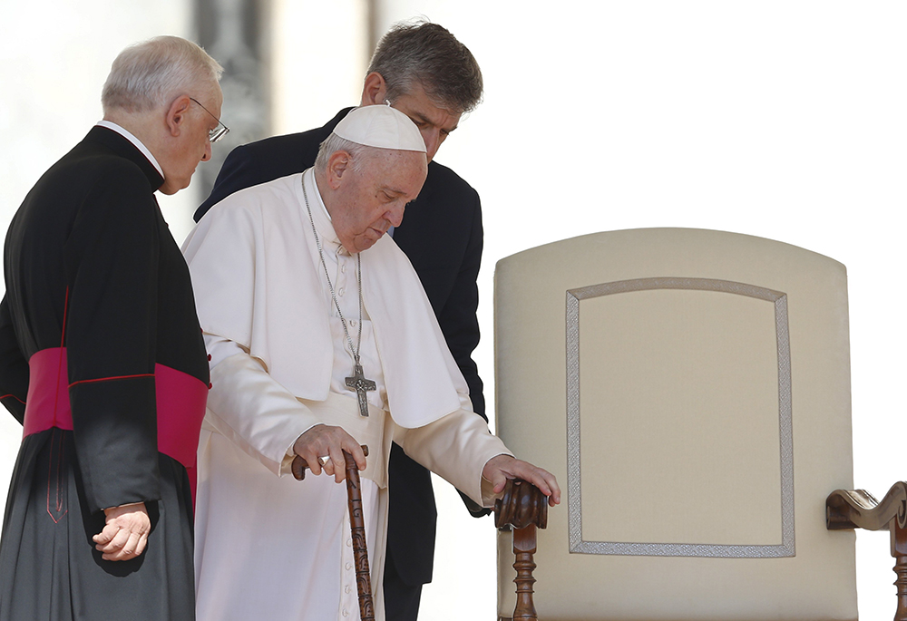 Pope Francis arrives at his chair during his general audience in St. Peter's Square June 8 at the Vatican. (CNS/Paul Haring)