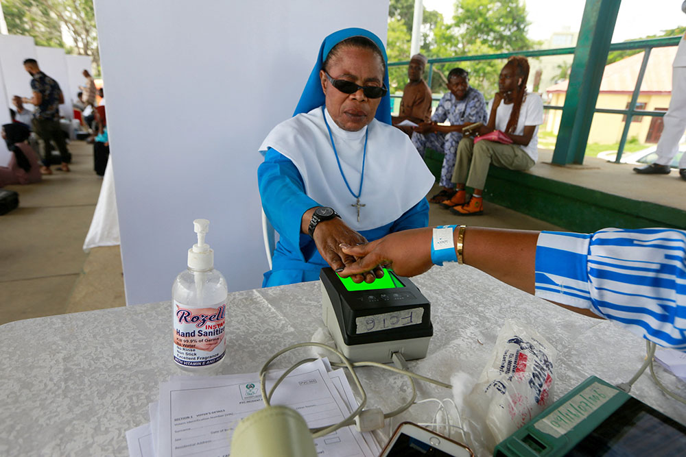 A nun has her fingerprints captured during the Independent National Electoral Commission voter registration exercise at a center in Abuja, Nigeria, June 23. (CNS/Reuters/Afolabi Sotunde)