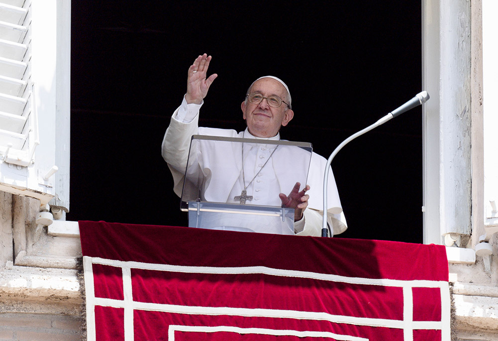 Pope Francis greets the crowd as he leads the Angelus from the window of his studio overlooking St. Peter's Square at the Vatican June 26. (CNS/Vatican Media)