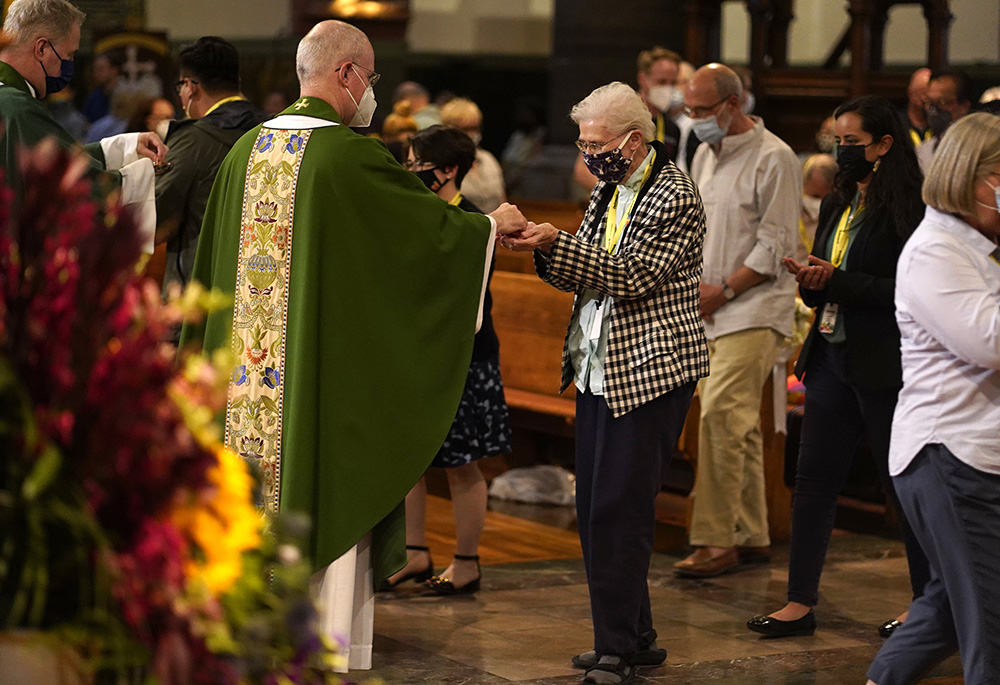 Loretto Sr. Jeannine Gramick receives Communion from Jesuit Fr. James Martin, author and editor at large of America Media, during a Mass at St. Paul the Apostle Church June 25 in New York City, for participants of the Outreach conference. (CNS) Loretto Sr. Jeannine Gramick receives Communion from Jesuit Fr. James Martin, author and editor at large of America Media, during a Mass at St. Paul the Apostle Church June 25 in New York City, for participants of the Outreach conference. (CNS)