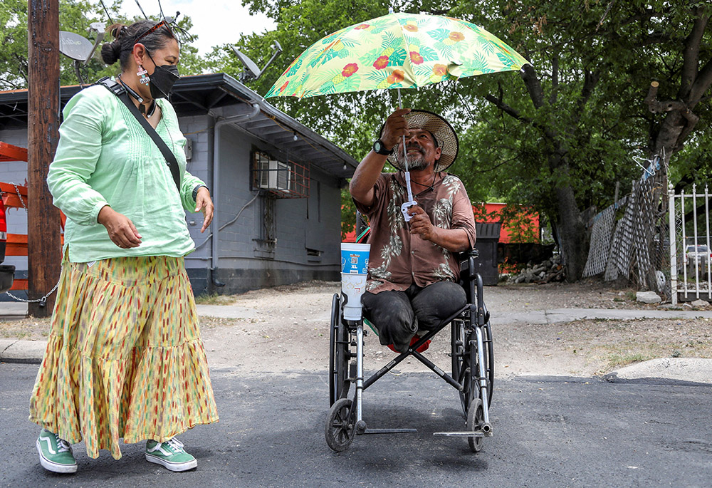 Susana Segura, with Bread and Blankets Mutual Aid, left, gives out water, bananas and hats to unhoused people and others in need during a heat advisory July 21 in San Antonio. (CNS/Reuters/Lisa Krantz) Susana Segura, with Bread and Blankets Mutual Aid, left, gives out water, bananas and hats to unhoused people and others in need during a heat advisory July 21 in San Antonio. (CNS/Reuters/Lisa Krantz)
