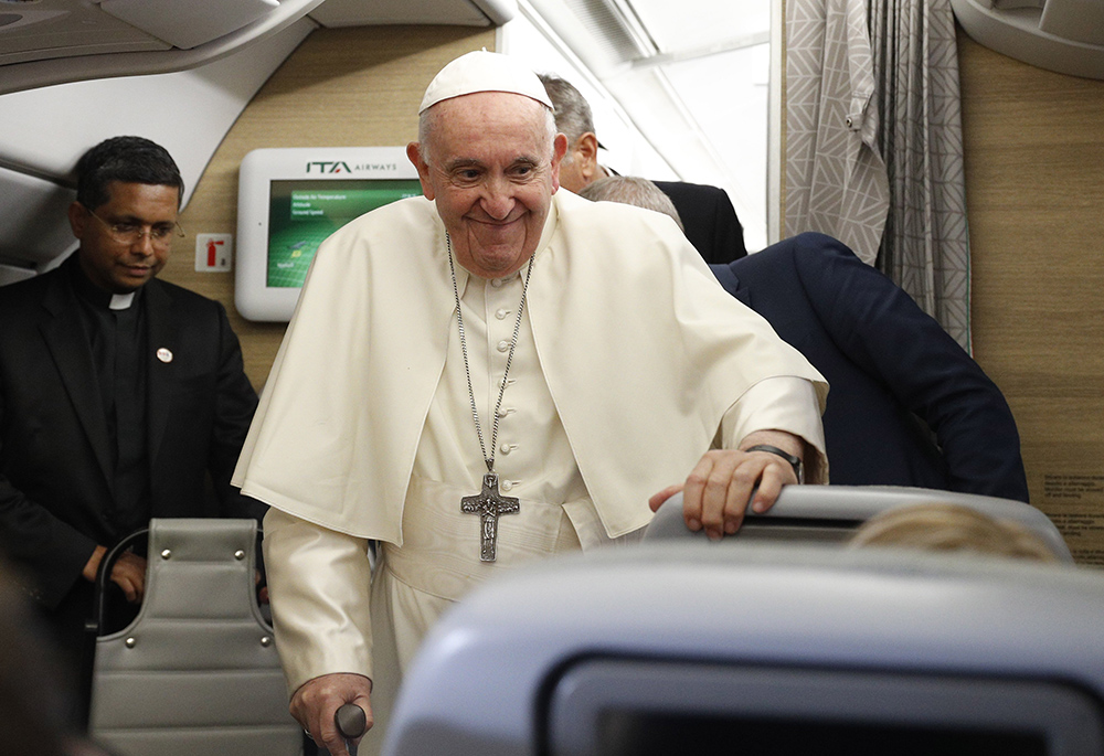 Pope Francis arrives to answer questions from journalists aboard his flight from Iqaluit, in the Canadian territory of Nunavut, to Rome July 29. (CNS/Paul Haring)