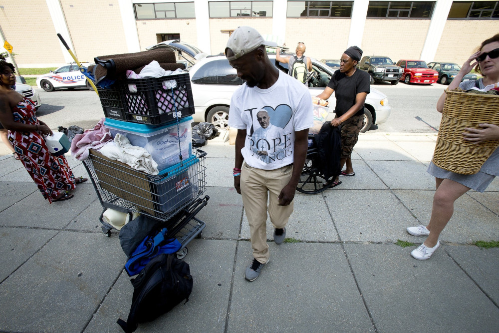 Eric Sheptock, an advocate for the homeless in Washington, helps other people move their belongings June 22, 2017, after police told them they had to move.
