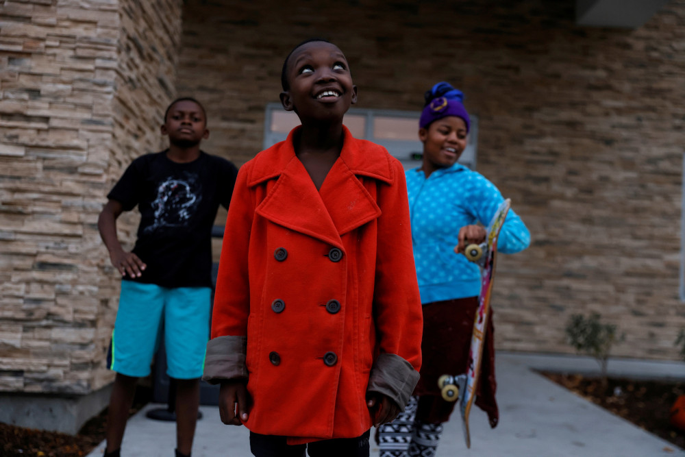 Children from Congo who have received refugee status in the U.S. stand outside a temporary hotel residence in Boise, Idaho, Oct. 29, 2021