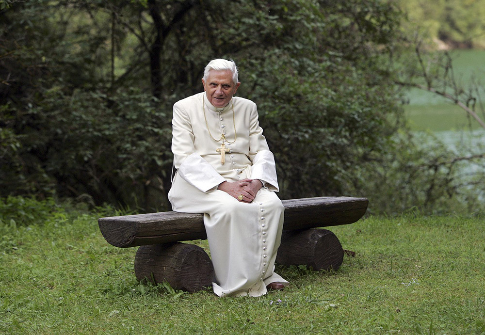 Pope Benedict XVI poses for photos on a bench outside the Madonna della Salute chapel in Lorenzago di Cadore, a small town in northern Italy's mountain region July 23, 2007. Throughout the year, the pope and Vatican officials gave increased attention to environmental concerns. (CNS/Catholic Press Photo/Alessia Giuliani) (Dec. 13, 2007)