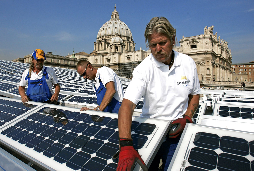 SolarWorld workers install solar panels on the roof of the Paul VI audience hall at the Vatican in October 2008. The solar power system was inaugurated at the Vatican Nov. 26 that year. (CNS/Catholic Press Photo/Emanuela De Meo)