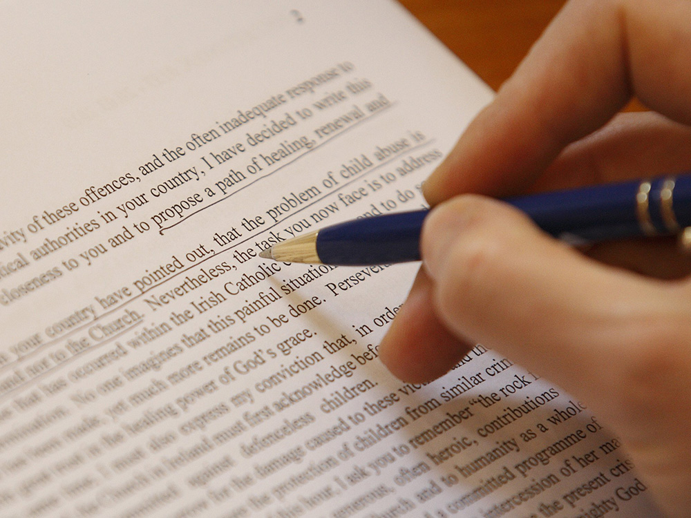 A reporter reviews Pope Benedict XVI's pastoral letter to Ireland's Catholics after its release at the Vatican press office March 20, 2010. In the letter, Benedict apologized to victims of clerical sexual abuse and announced steps to heal wounds of the scandal. (CNS/Paul Haring)