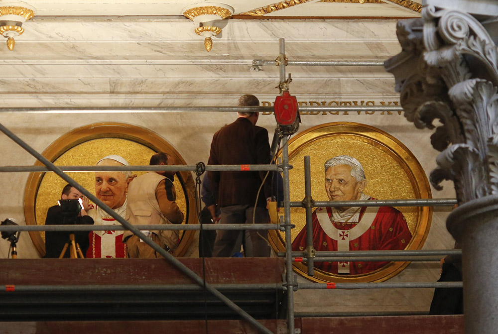 Workers install a mosaic depicting Pope Francis next to the one depicting Pope Benedict XVI in St. Paul's Basilica in Rome Dec. 9, 2013. (CNS/Reuters/Alessandro Bianchi)