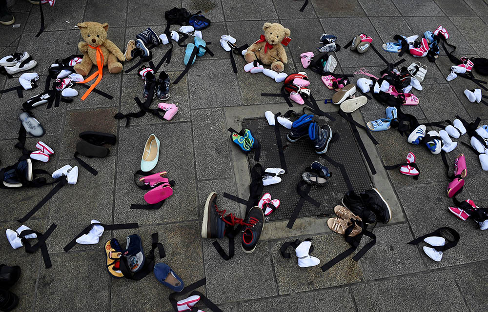 Children's shoes and toys are seen on a sidewalk in Dublin Aug. 25, 2018, as part of a demonstration against clerical sex abuse in the archdiocese. (CNS/Reuters/Clodagh Kilcoyne)