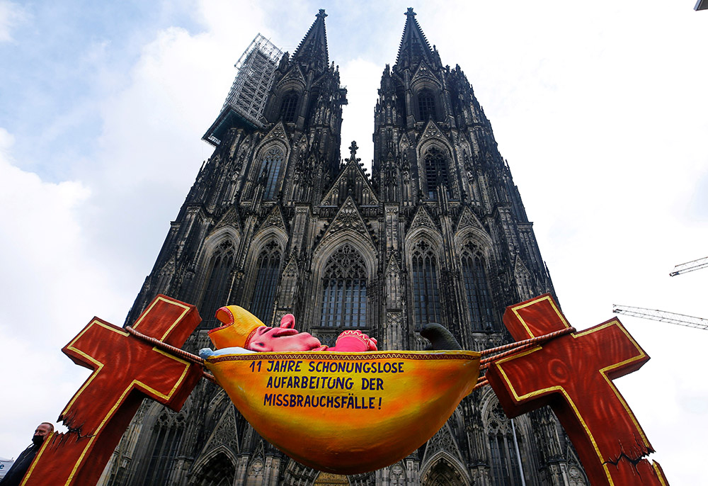A carnival float showing an unnamed bishop is placed in front of the Catholic cathedral by activists protesting sexual abuse by priests in Cologne, Germany, March 18, 2021. The wording on the float reads "11 years of brutal honest reconnaissance of sexual abuse." (CNS/Reuters/Thilo Schmuelgen)
