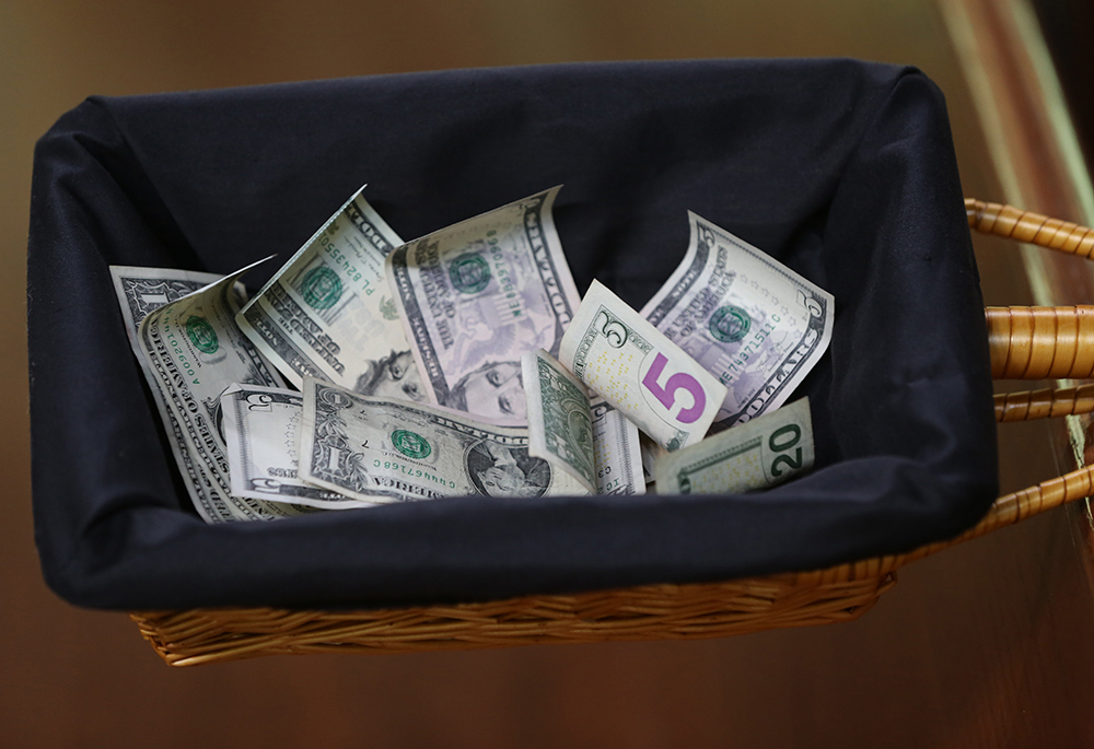A collection basket with donations is pictured in an illustration. (CNS/Bob Roller)