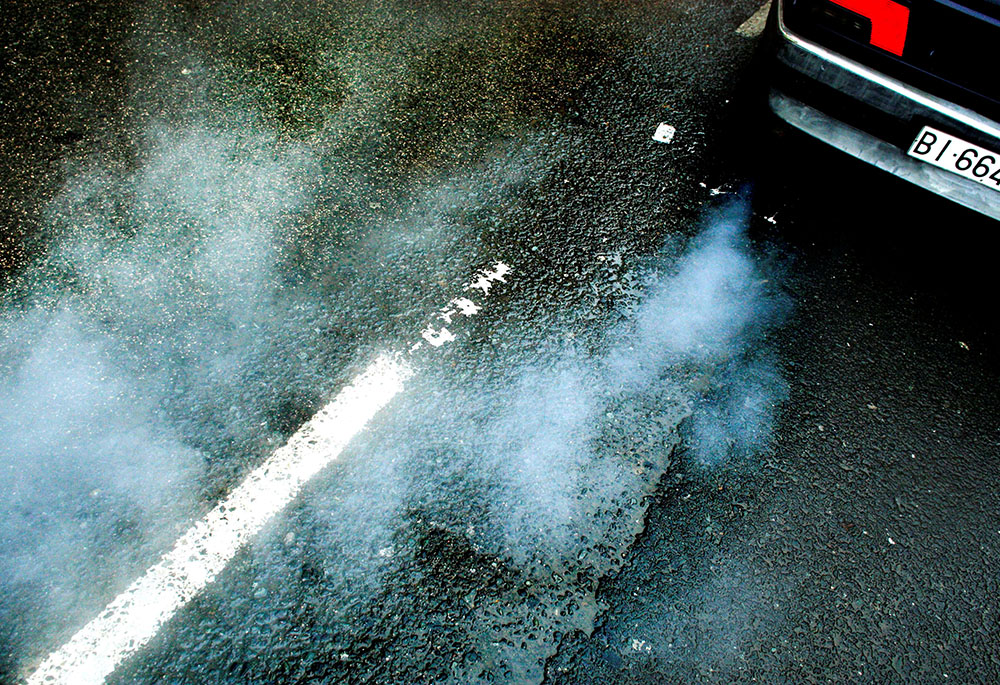 A car produces smoke from its exhaust Oct. 29, 2007. (CNS/Reuters/Vincent West)