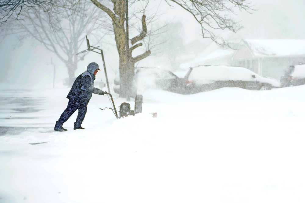 Brian Rhodes uses a snow blower to clear his driveway in Stony Brook, N.Y., during a blizzard that swept through parts of the Northeast U.S. Jan. 29, 2022. (CNS/Gregory A. Shemitz)
