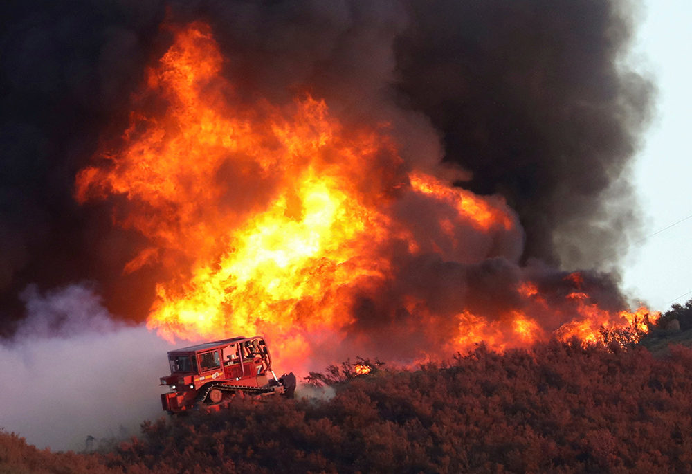 A bulldozer is at the edge of the Route Fire burning Aug. 31, 2022, near Castaic, California. (CNS/Reuters/David Swanson)