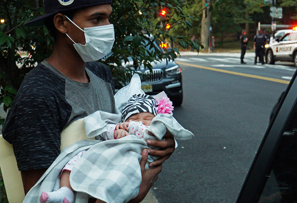 A 1-month-old baby is placed into a vehicle for transport to a safe place in Washington Sept. 17, 2022, after a group of mainly Venezuelan migrants arrived by bus from detention in Texas and were dropped off outside the Naval Observatory, the official residence of Vice President Kamala Harris. (CNS/Reuters/Marat Sadana)
