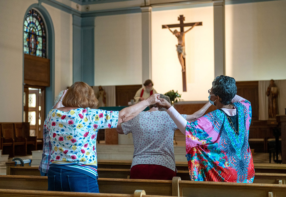A handful of parishioners in the Gardenville neighborhood of Baltimore attend daily Mass Sept. 16, 2022, at St. Anthony of Padua Catholic Church. (CNS/Catholic Review/Kevin J. Parks)