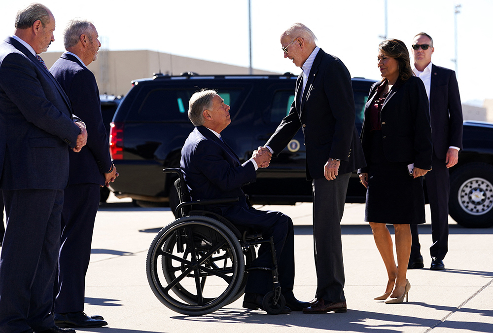 U.S. President Joe Biden shakes hands with Texas Gov. Greg Abbott upon Biden's arrival to the U.S.-Mexico border to assess border enforcement operations Jan. 8 in El Paso. (OSV News/Reuters/Kevin Lamarque)