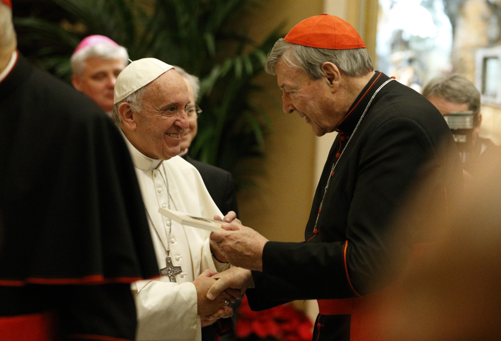 Pope Francis greets Australian Cardinal George Pell, prefect of the Secretariat for the Economy, during an audience to exchange greetings with members of the Roman Curia in Clementine Hall of the Apostolic Palace at the Vatican in this Dec. 22, 2016, file photo. Cardinal Pell, former prefect of the Vatican's Secretariat for the Economy, died Jan. 10 in Rome at the age of 81. (CNS photo/Paul Haring)