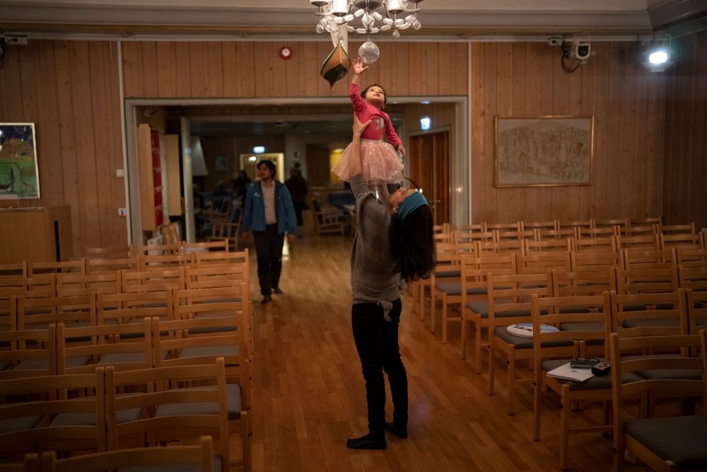 Neelu Singh holds her daughter Svalbie after a service at Svalbard Kirke in Longyearbyen, Norway, Sunday, Jan. 8, 2023. (AP/Daniel Cole)