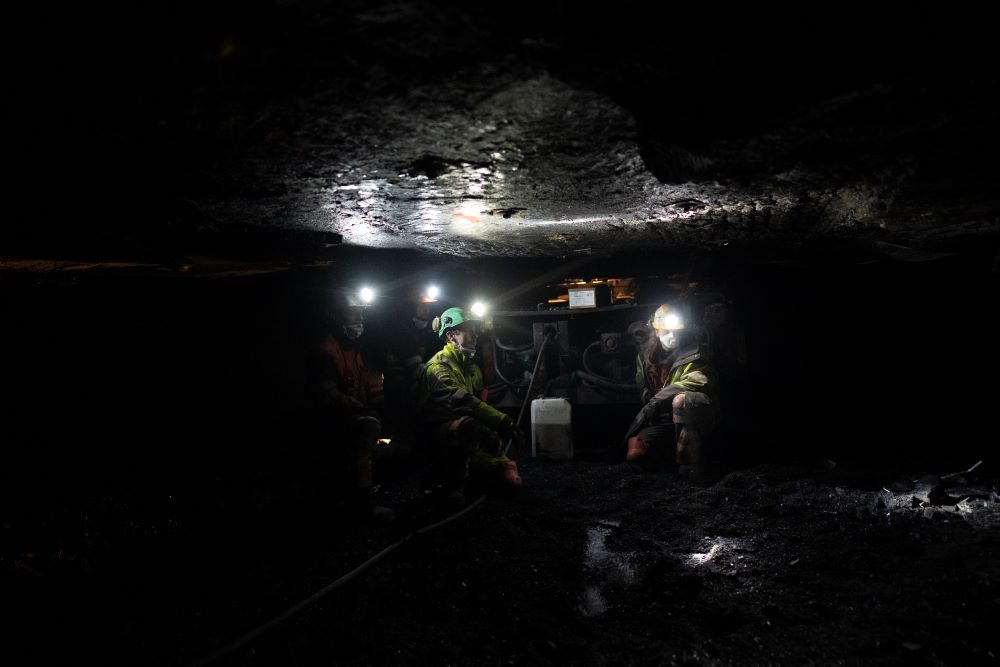 Coal miners refill a machine with oil at the bottom of the Gruve 7 coal mine in Adventdalen, Norway, Monday, Jan. 9, 2023. (AP/Daniel Cole)