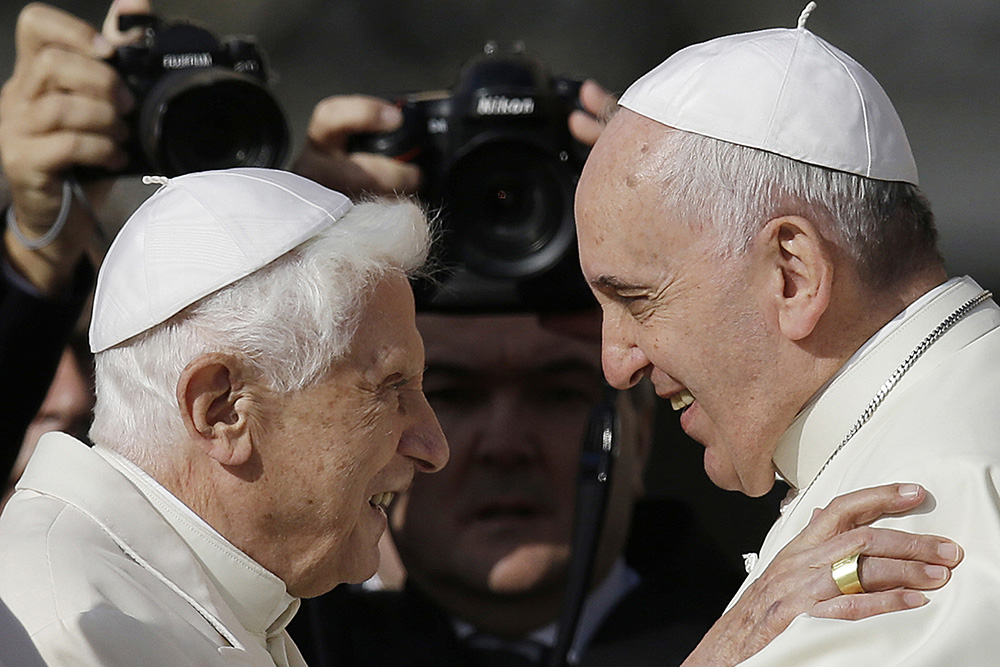On Sept. 28, 2014, Pope Francis, right, hugs Emeritus Pope Benedict XVI prior to the start of a meeting with elderly faithful in St. Peter's Square at the Vatican. (AP/Gregorio Borgia, File)