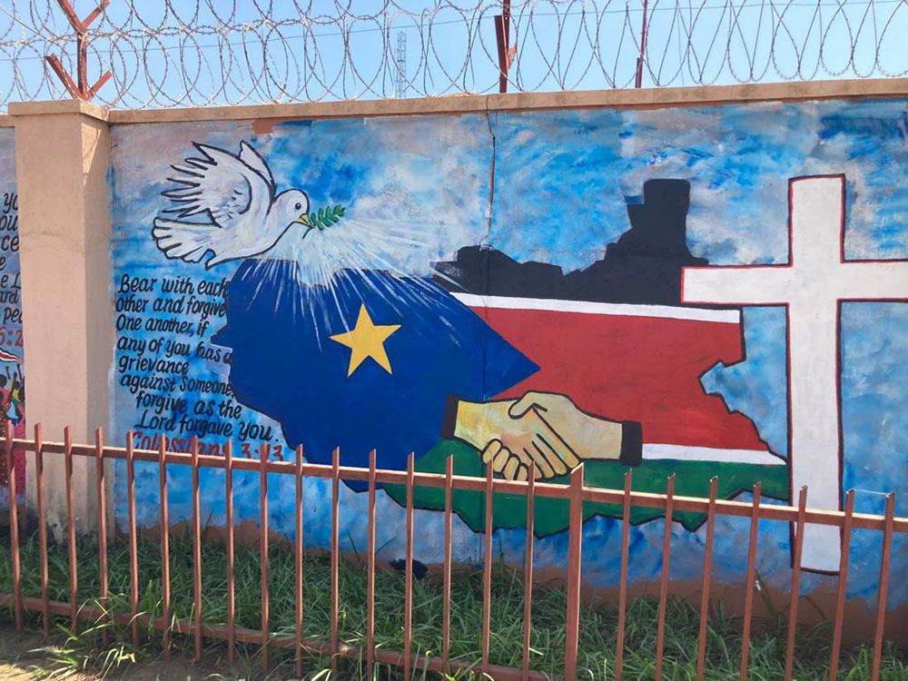 A mural with the official logo of the ecumenical peace pilgrimage to South Sudan is painted on the walls of the South Sudan Council of Churches in Juba. (Elizabeth Boyle)