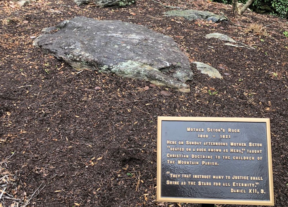 A plaque displayed at the National Shrine Grotto of Our Lady of Lourdes in Emmitsburg, Maryland explains how St. Elizabeth Ann Seton would sit on "her rock" and teach the children. (Courtesy of the National Shrine Grotto)