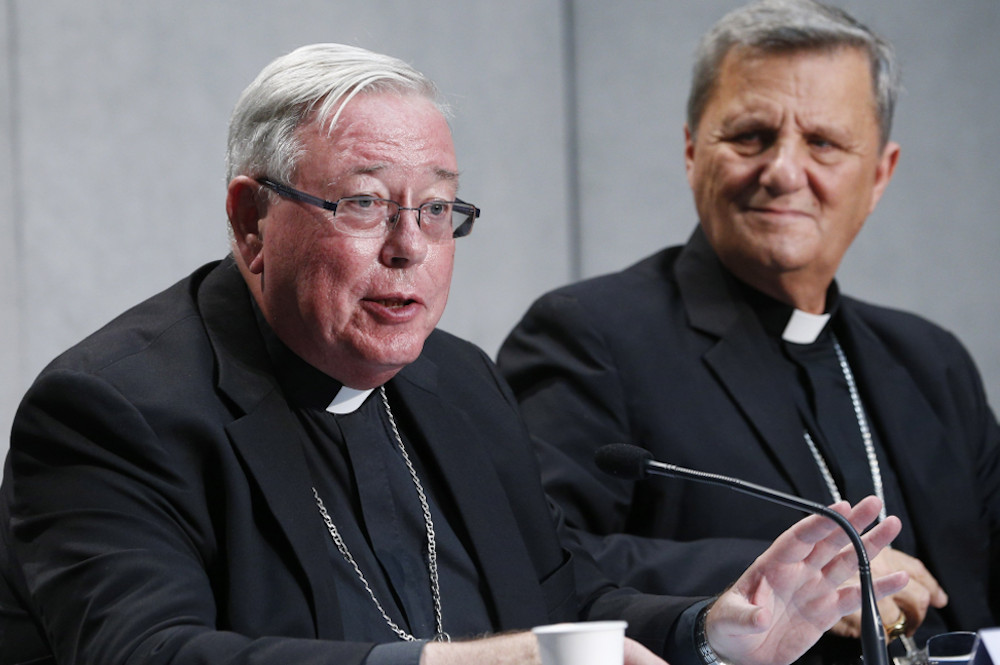 Cardinal Jean-Claude Hollerich of Luxembourg, relator general of the Synod of Bishops, speaks at a news conference to present an update on the synod process, at the Vatican in this Aug. 26, 2022, file photo. Looking on is Cardinal Mario Grech, secretary-general of the synod. (CNS/Paul Haring)