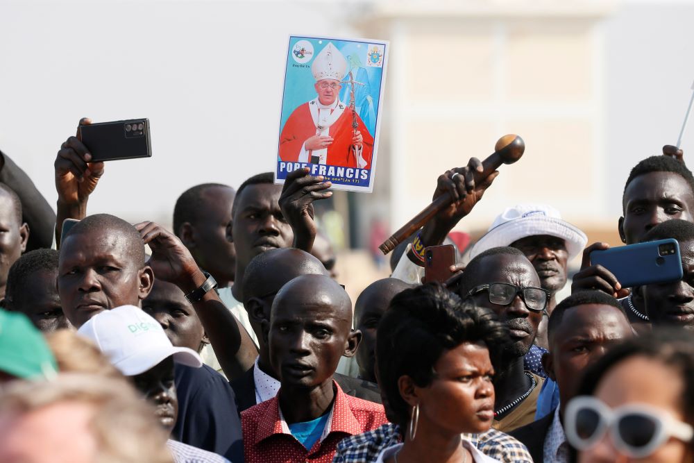 A picture of Pope Francis is seen in the crowd as the pope attends a welcoming ceremony at the international airport in Juba, South Sudan, Feb. 3. (CNS/Paul Haring)