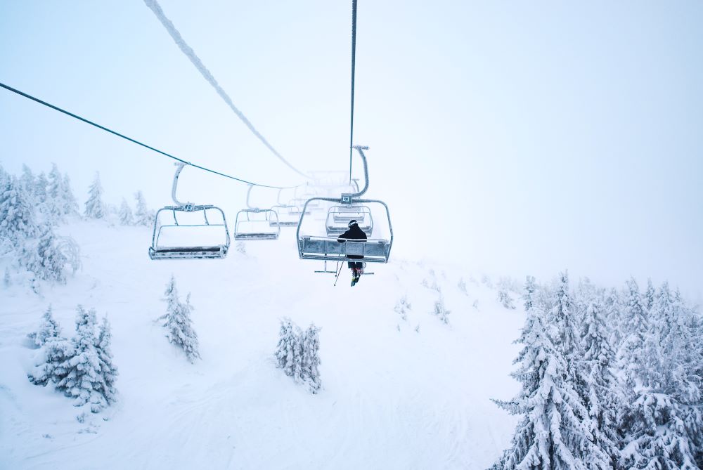 ski lift above snowy hills