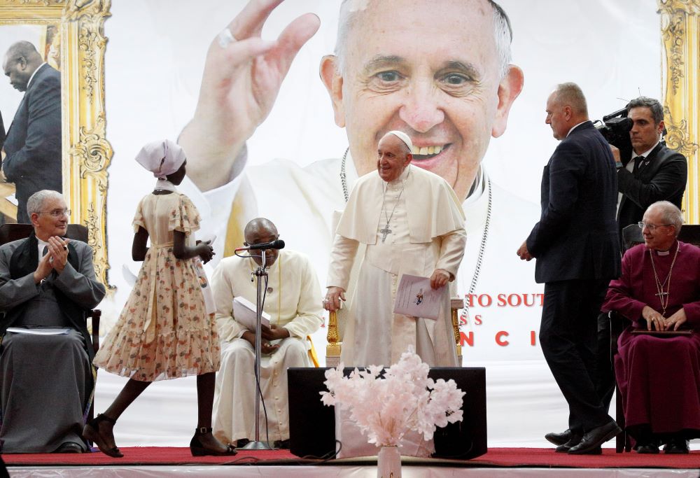 Pope Francis greets an internally displaced young woman during a meeting with internally displaced people at Freedom Hall in Juba, South Sudan, Feb. 4. Also pictured are Rev. Iain Greenshields, left, moderator of the Presbyterian Church of Scotland, and Anglican Archbishop Justin Welby, right. (CNS/Paul Haring)