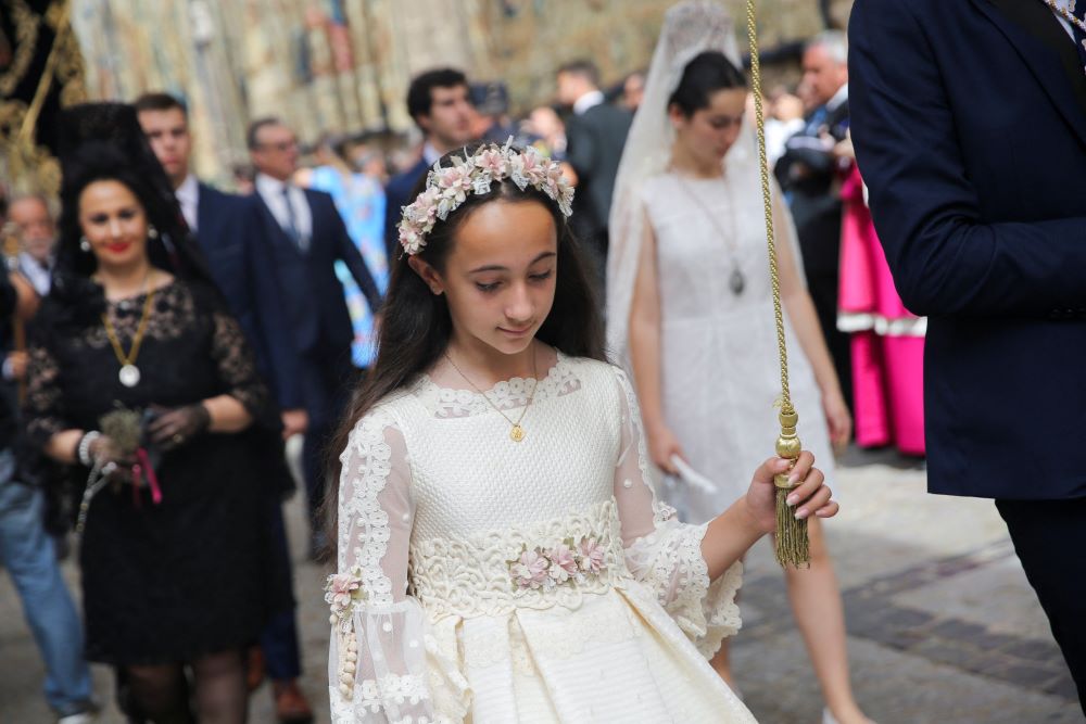 A young woman takes part in a procession on the feast of Corpus Christi in Toledo, Spain, June 16, 2022. (CNS/Reuters/Isabel Infantes)