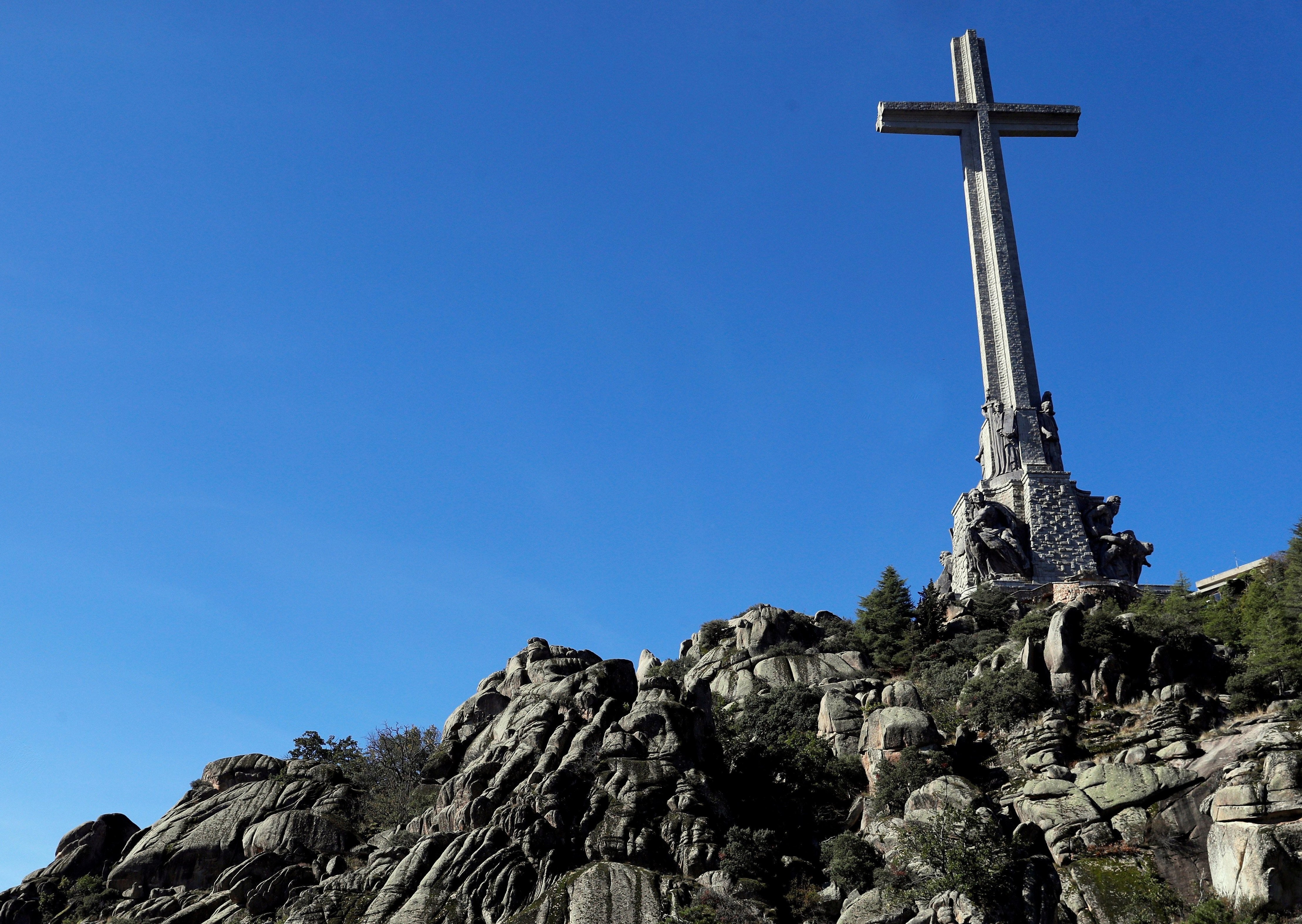 A helicopter carrying the coffin of former Spanish dictator Gen. Francisco Franco flies above the mausoleum where the tomb of former Spanish dictator was located in the Valley of the Fallen near Madrid before it was exhumed Oct. 24, 2019. (CNS photo/Emilio Naranjo, pool via Reuters)