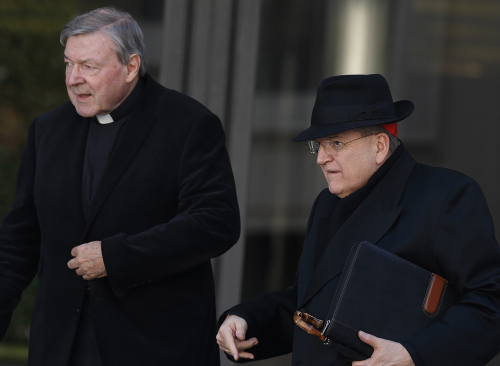 Australian Cardinal George Pell and U.S. Cardinal Raymond Burke leave a meeting of Pope Francis and cardinals in the synod hall at the Vatican Feb. 21, 2014. (CNS/Paul Haring)