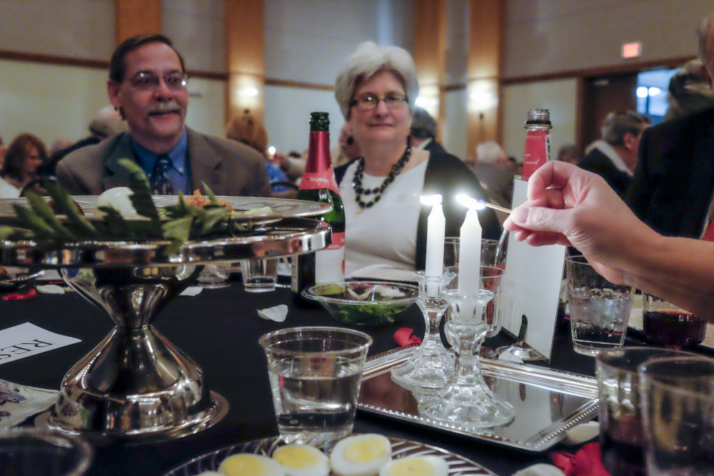 The Jewish Federation of Nashville and Middle Tennessee light candles April 12, 2016, at a community relations Seder at the Gordon Jewish Community Center in Nashville. (CNS/Tennessee Register/Rick Musacchio)