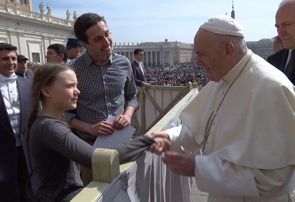 Pope Francis greets 16-year-old Swedish climate activist Greta Thunberg, with Tomás Insua by her side, during his general audience in St. Peter's Square April 17, 2019, at the Vatican. (CNS/Reuters/Yara Nardi)