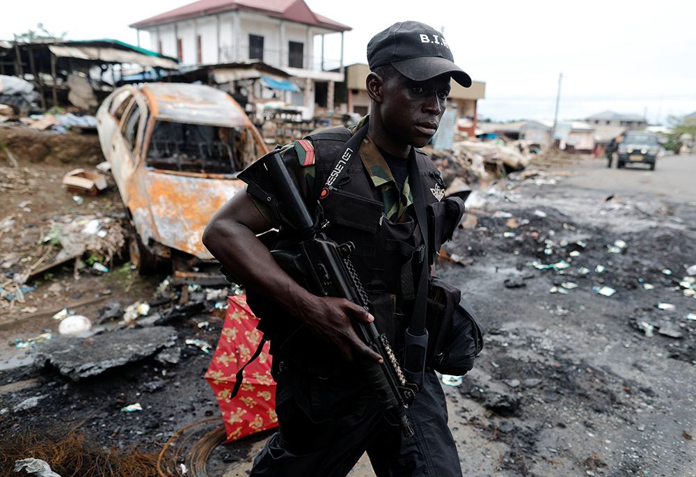 A Cameroonian elite Rapid Intervention Battalion member patrols the abandoned village of Ekona Oct. 4, 2018, in the Anglophone region of Cameroon. (CNS/Reuters/Zohra Bensemra)