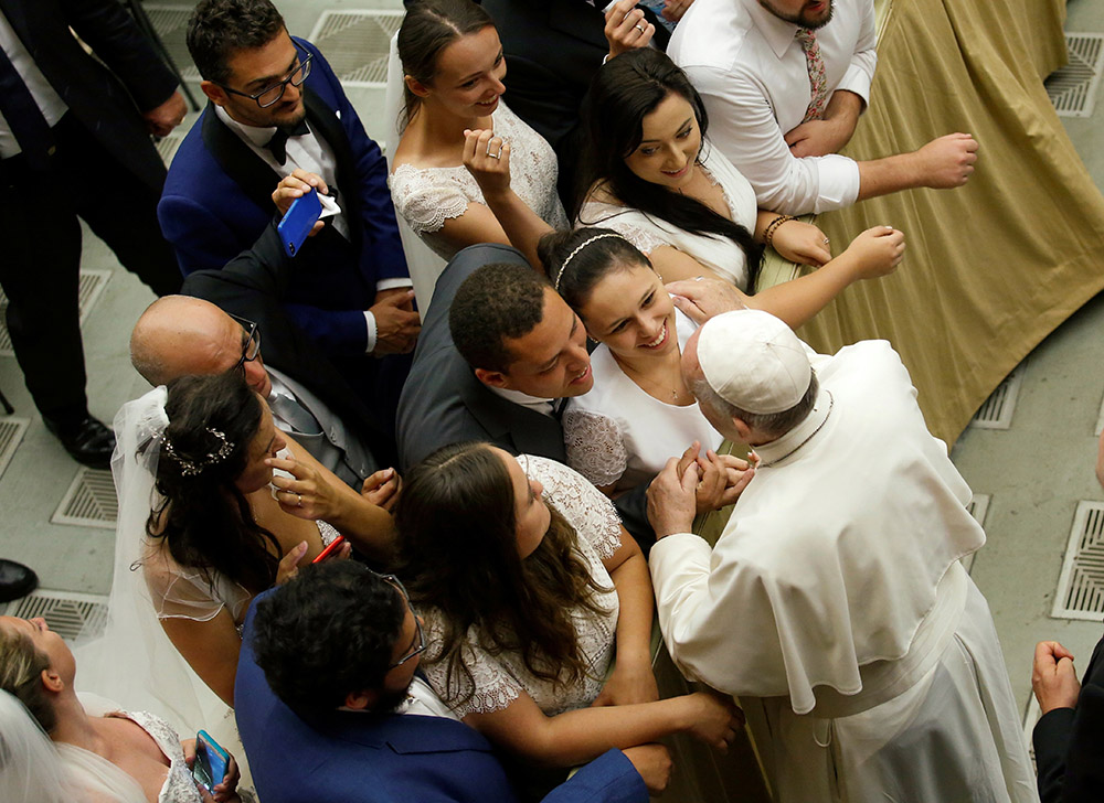 Pope Francis greets a group of newlyweds during his general audience in Paul VI hall at the Vatican Aug. 21, 2019. (CNS/Reuters/Remo Casilli)