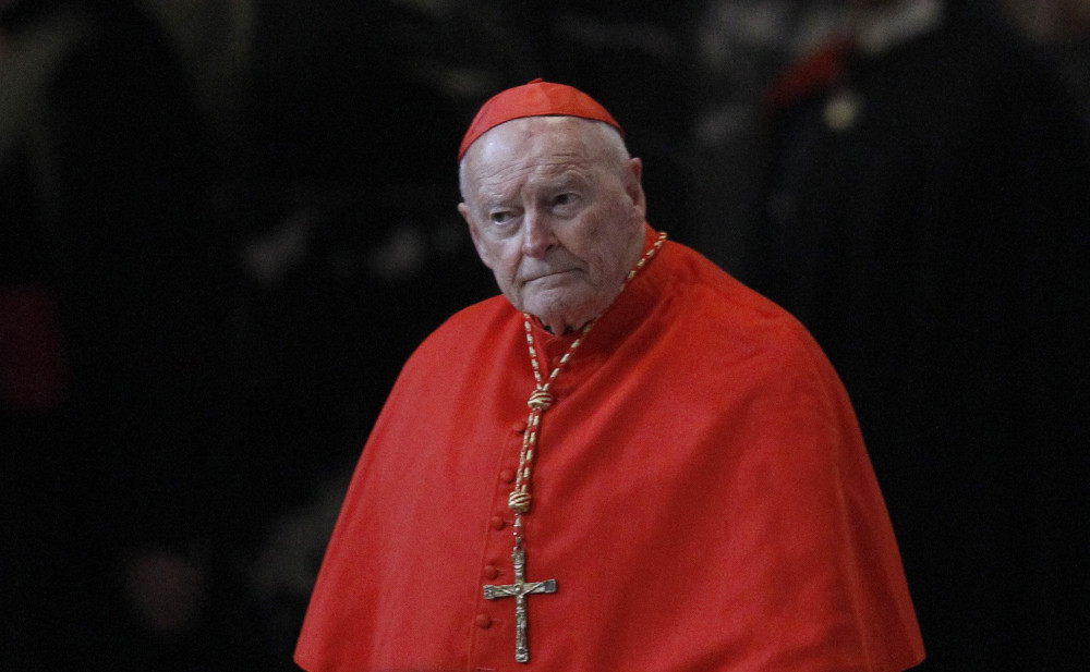 McCarrick wears a cardinal's red zucchetto and cape as well as a large pectoral cross