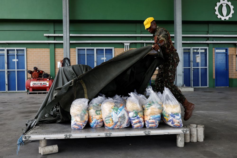 A member of the Brazilian Air Force prepares a platform loaded with food bags to be launched to the Surucucu base at Yanomami indigenous territory in Boa Vista, Brazil, Feb. 2, 2023. (OSV News/Reuters/Amanda Perobelli)