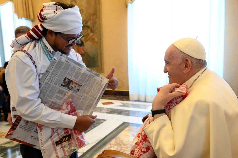 Pope Francis greets a participant from the International Fund for Agricultural Development's Indigenous Peoples' Forum during an audience at the Vatican Feb. 10, 2023. (CNS photo/Vatican Media)