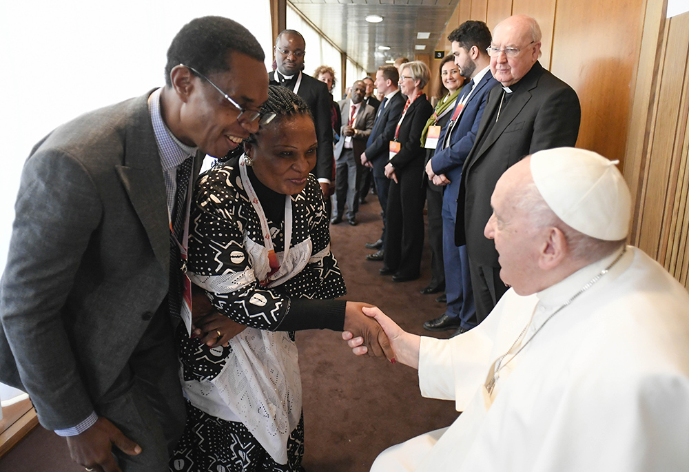 Pope Francis greets participants after speaking at a Vatican conference, "Pastors and lay faithful called to walk together," Feb. 18 in the Vatican Synod Hall. The meeting was sponsored by the Dicastery for Laity, the Family and Life. (CNS/Vatican Media)