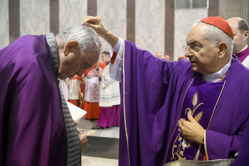 Cardinal Mauro Piacenza, head of the Apostolic Penitentiary, sprinkles ashes on the head of Pope Francis during Ash Wednesday Mass at the Basilica of Santa Sabina in Rome Feb. 22, 2023. (CNS photo/Vatican Media)