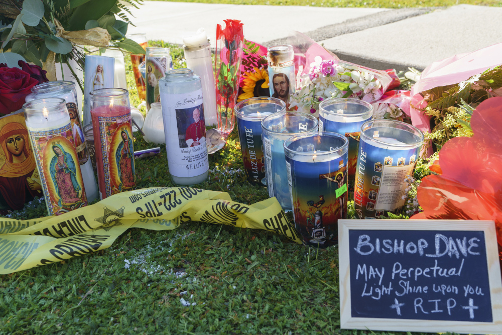 Candles and messages are left near Bishop David O'Connell's residence in Hacienda Heights, California, Feb. 19. O'Connell was shot and killed Saturday just blocks from a church, a slaying of a longtime priest hailed as a "peacemaker" that's stunned the Los Angeles religious community, authorities said. (AP/Damian Dovarganes)