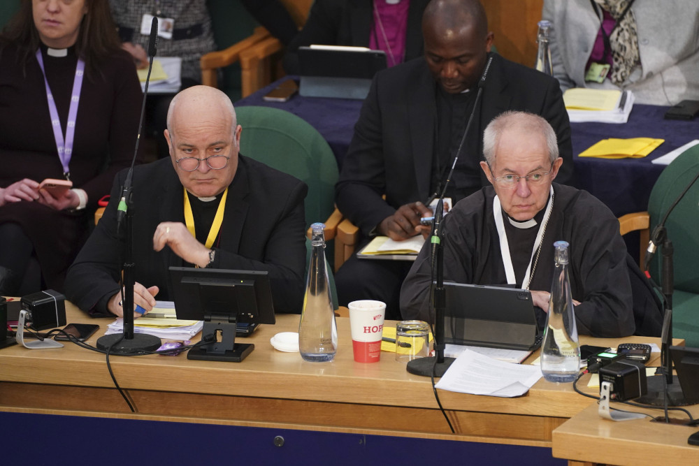 The Archbishop of York, Stephen Cottrell, left and the Archbishop of Canterbury, Justin Welby, gather at the General Synod of the Church of England, at Church House, to consider a motion which reviews the church's failure "to be welcoming to LGBTQI+ people" and the harm they have faced and still experience, in London, Thursday, Feb. 9, 2023. (James Manning/PA via AP)