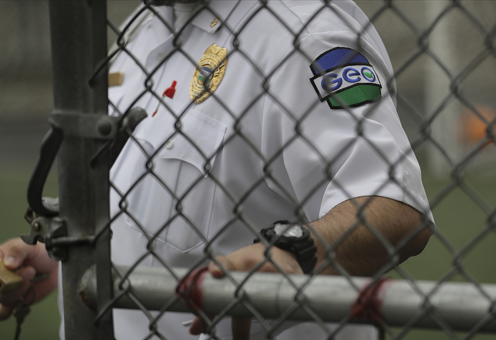 A patch is shown on the uniform of a guard with the GEO Group, Inc., during a media tour of the U.S. Immigration and Customs Enforcement detention center, Dec. 16, 2019, in Tacoma, Washington. The GEO Group is a private prison company that operates two central California immigration detention centers, where 82 people began a hunger strike Feb. 17. (AP photo/Ted S. Warren)