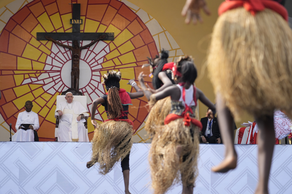 Pope Francis, second from left, watches traditional dancers perform at the Martyrs' Stadium in Kinshasa, Democratic Republic of the Congo Feb. 2. (AP/Gregorio Borgia)