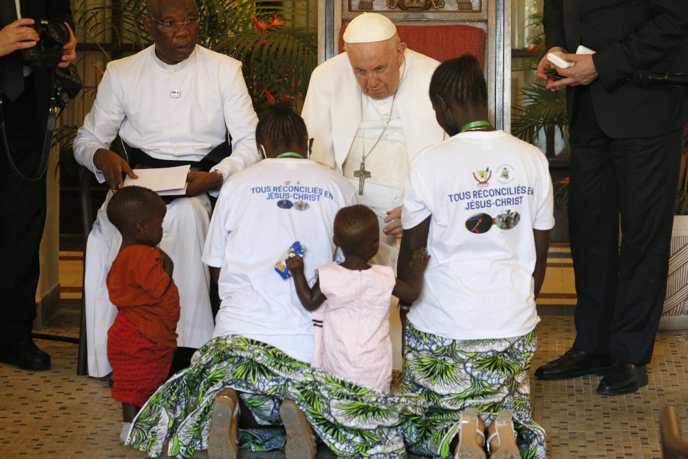 Pope Francis blesses Bijoux Mukumbi Kamala, her twin daughters and her friend Legge Kissa Catarina during a meeting with victims of violence from eastern Congo in the apostolic nunciature in Kinshasa Feb. 1. (CNS/Paul Haring)