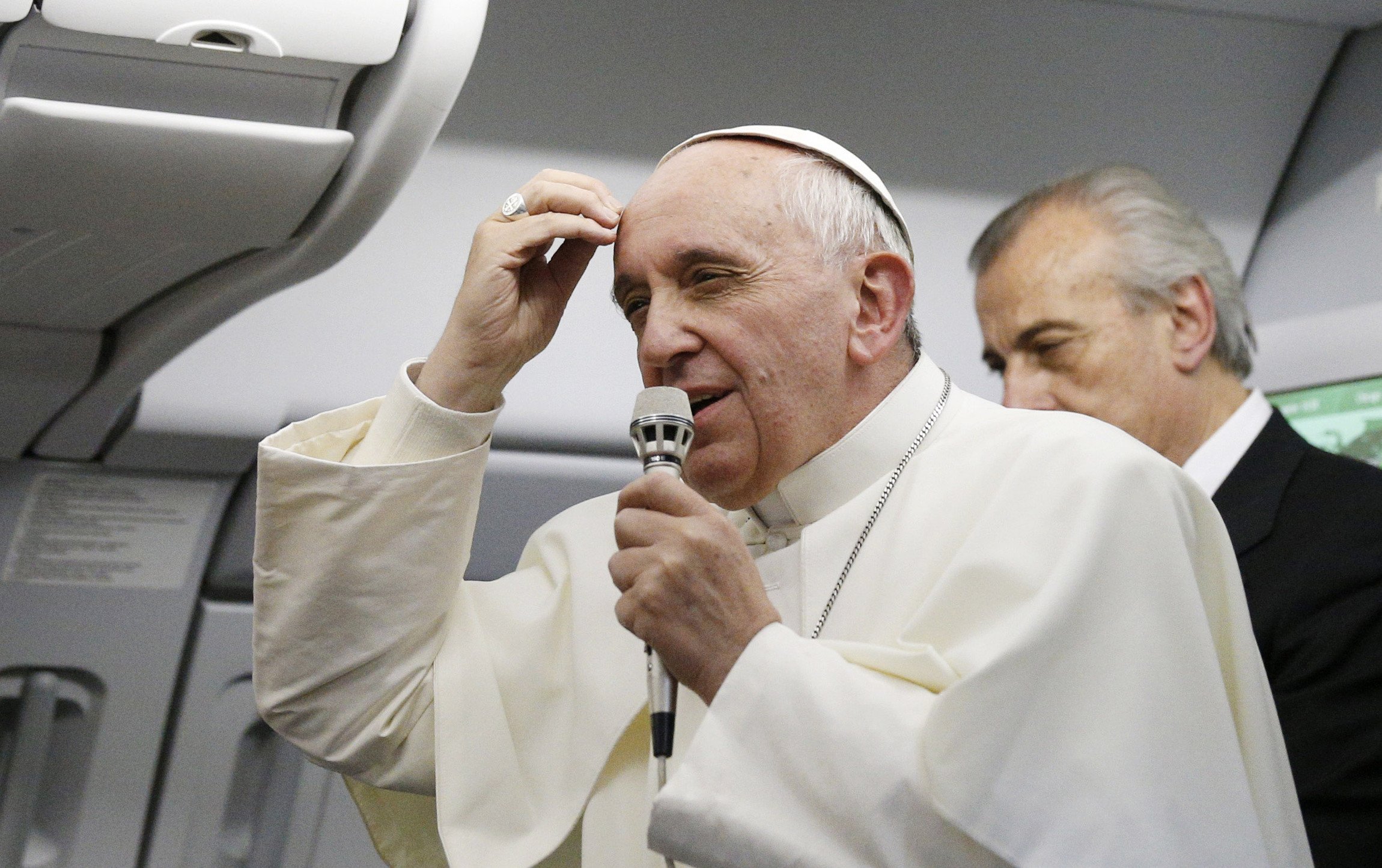 Pope Francis speaks to the media aboard the papal flight from Rio de Janeiro to Rome July 28, 2013. When the pope told reporters, "Who am I to judge" a homosexual person, he was emphasizing a part of Catholic teaching often overlooked by the media and misunderstood by many people. (CNS/Paul Haring)