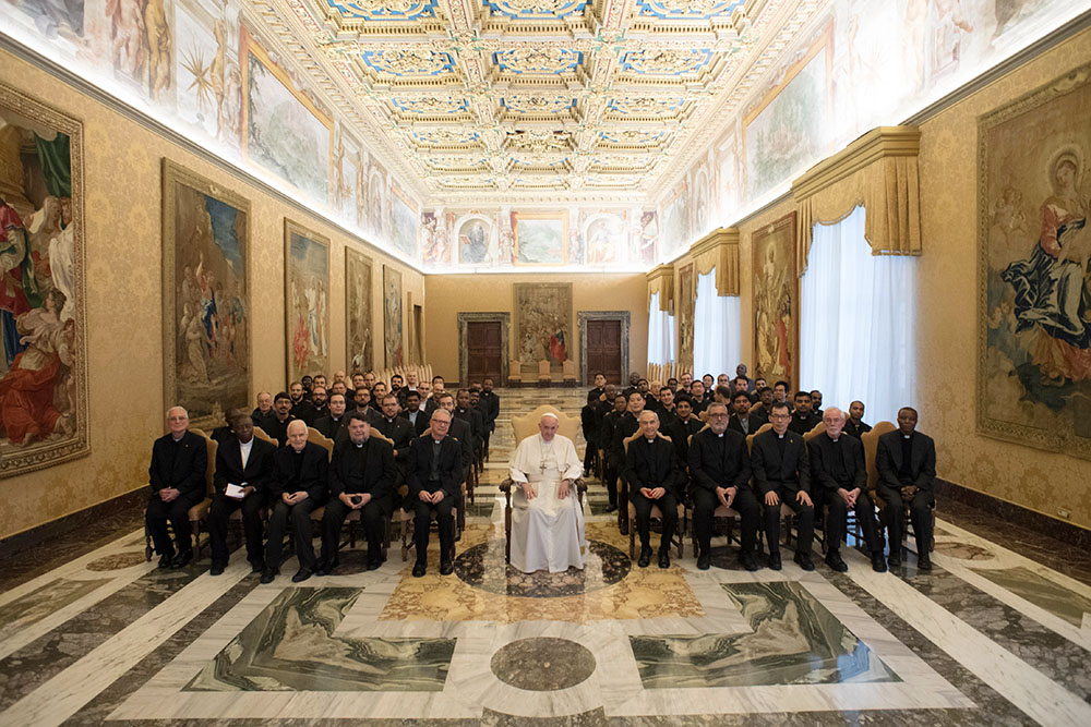 Pope Francis poses for a photo with faculty and staff of the Jesuits' International College of the Gesù in Rome during an audience at the Vatican Dec. 3, 2018. (CNS/Vatican Media)